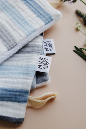Hanging loops on washcloths in Milk + Joy baby bath gift set for easy organization.