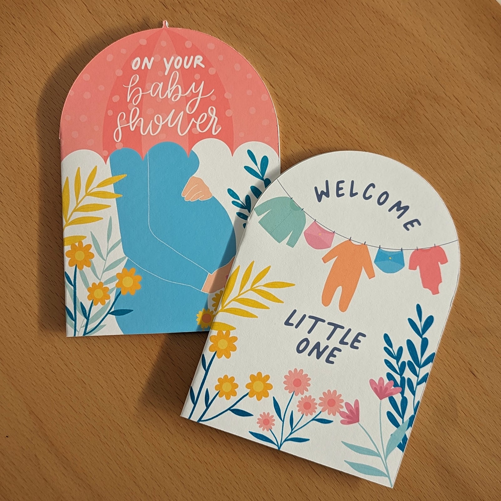 Milk + Joy baby shower and new baby greeting cards in signature brand colors, with floral and baby clothes designs.